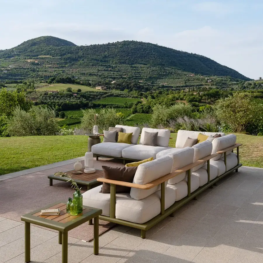 Superior Atmosphera Bliss sectional with a curved backrest, beige cushions and natural teak armrests in Gesso finish