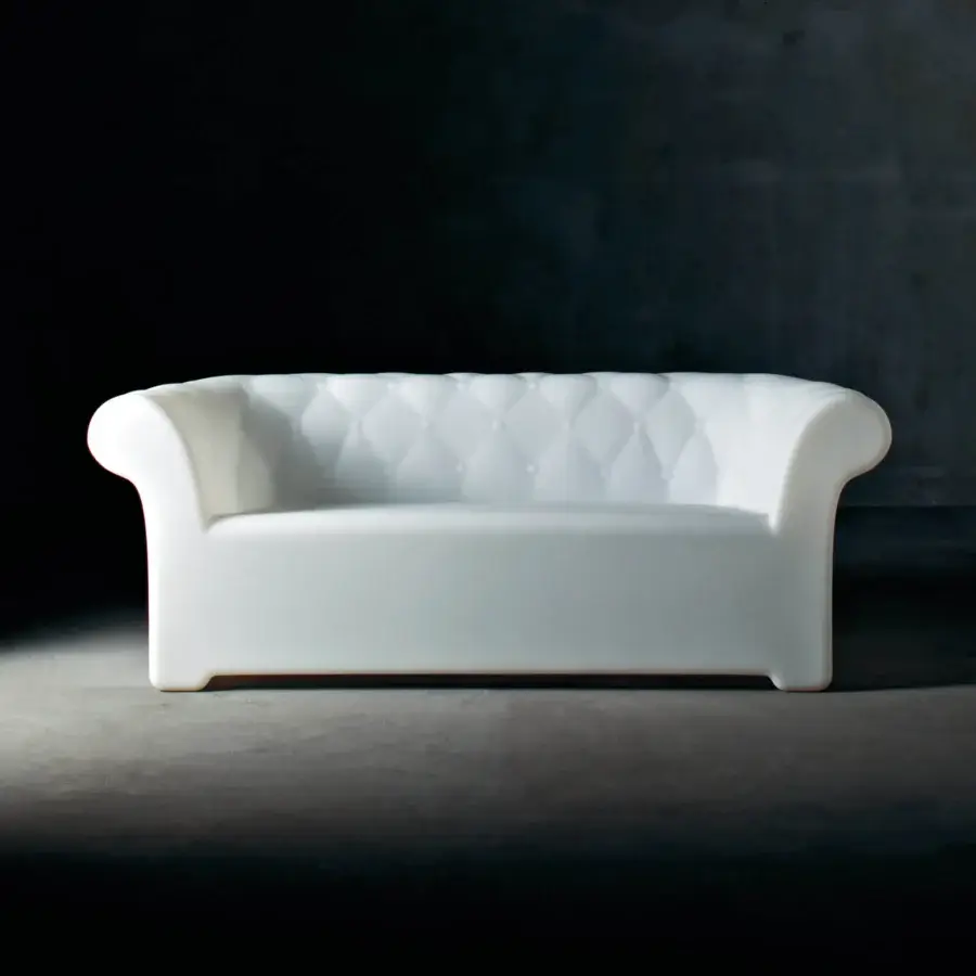 Elegant Serralunga Sirchester sofa crafted from glossy white LLDPE plastic with deeply button-tufted design for comfortable outdoor living