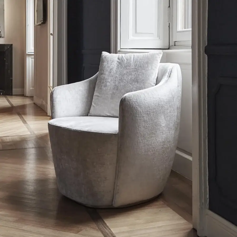 Exceptional Capital Audrey lounge chair upholstered in soft light gray fabric with a solid wooden frame and flowing organic form
