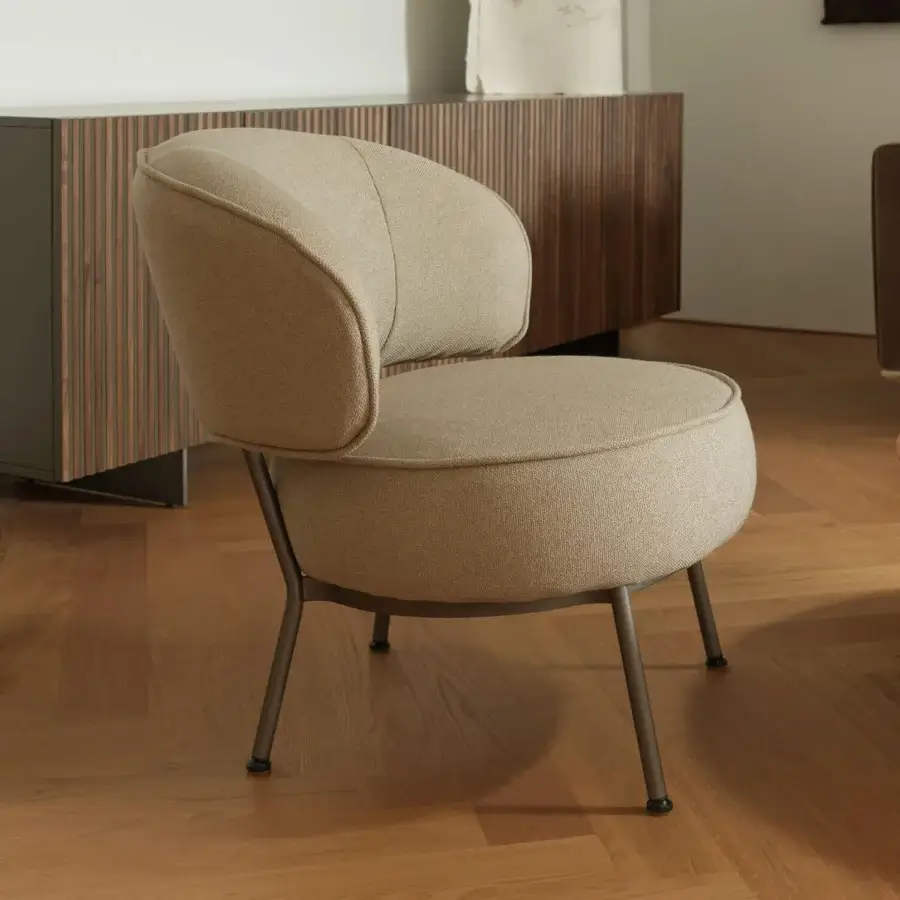 Elegant Horm Vendome lounge chair with muted beige textile upholstery and sleek dark gray metal base