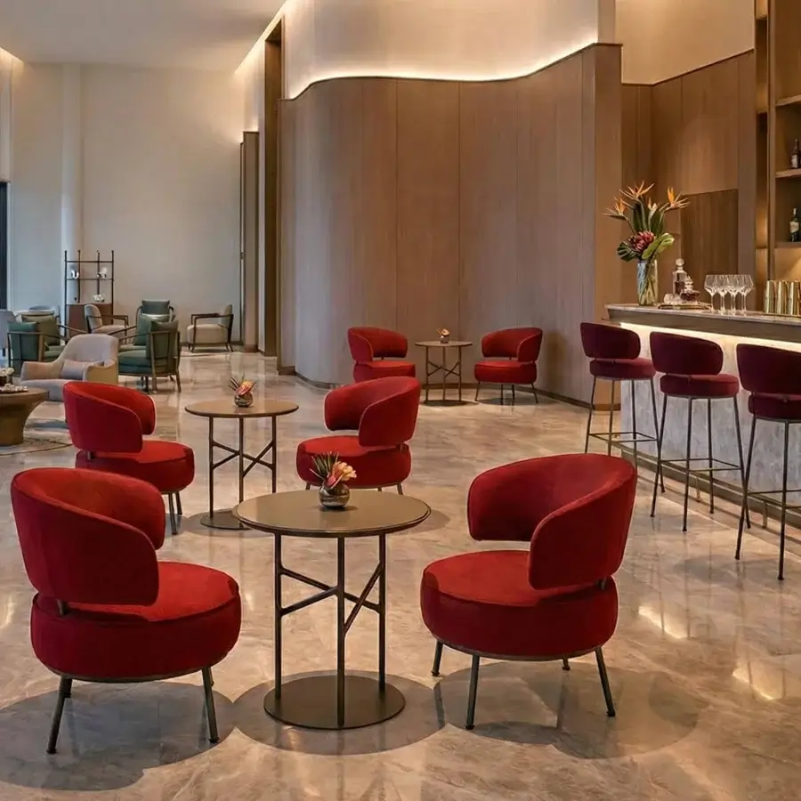 Sumptuous Horm Vendome lounge chair with saturated red velvet-like textile and slender dark metal frame