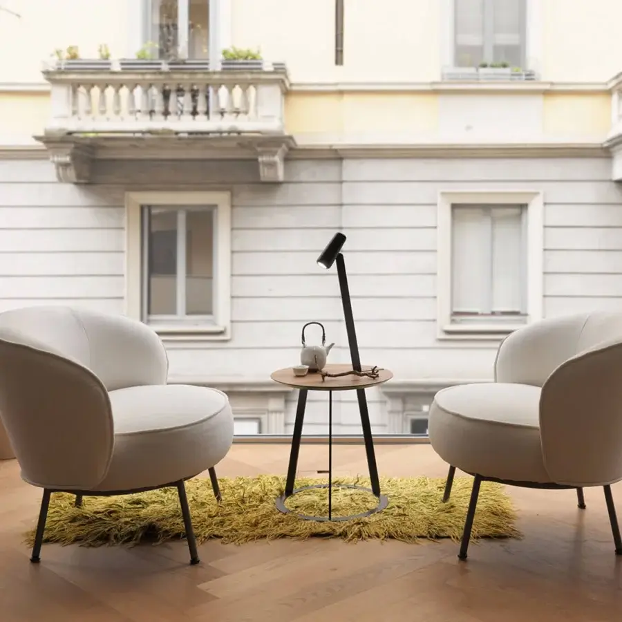Elegant Horm Concorde lounge chair with enveloping light beige textile and slender dark-toned metal legs