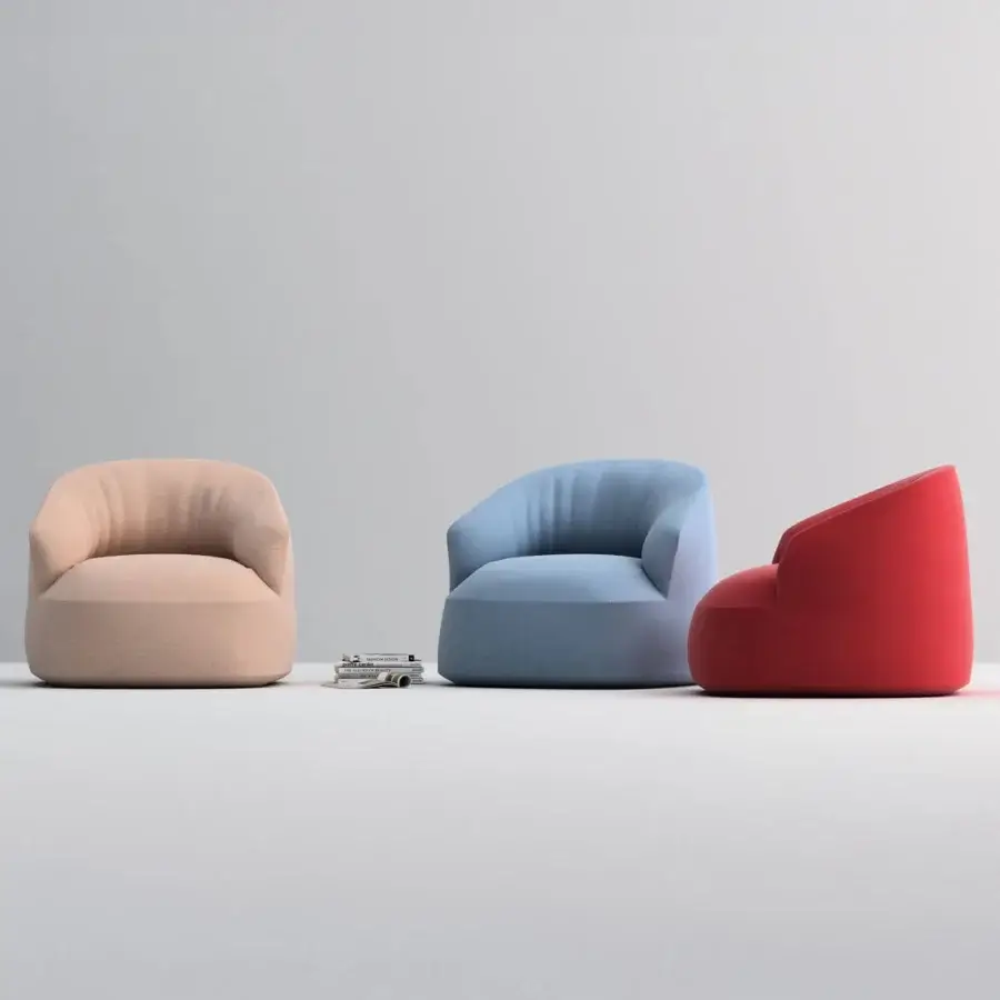 Elegant Horm Edith swivel lounge chair with organically rounded form upholstered in vibrant red matte textile