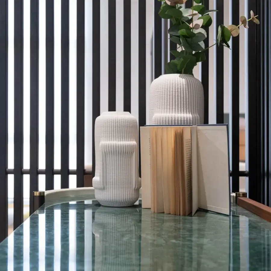 Superior Capital Karin sideboard with sculpted silhouette, leather upholstery, and a marble top revealing a glossy black interior