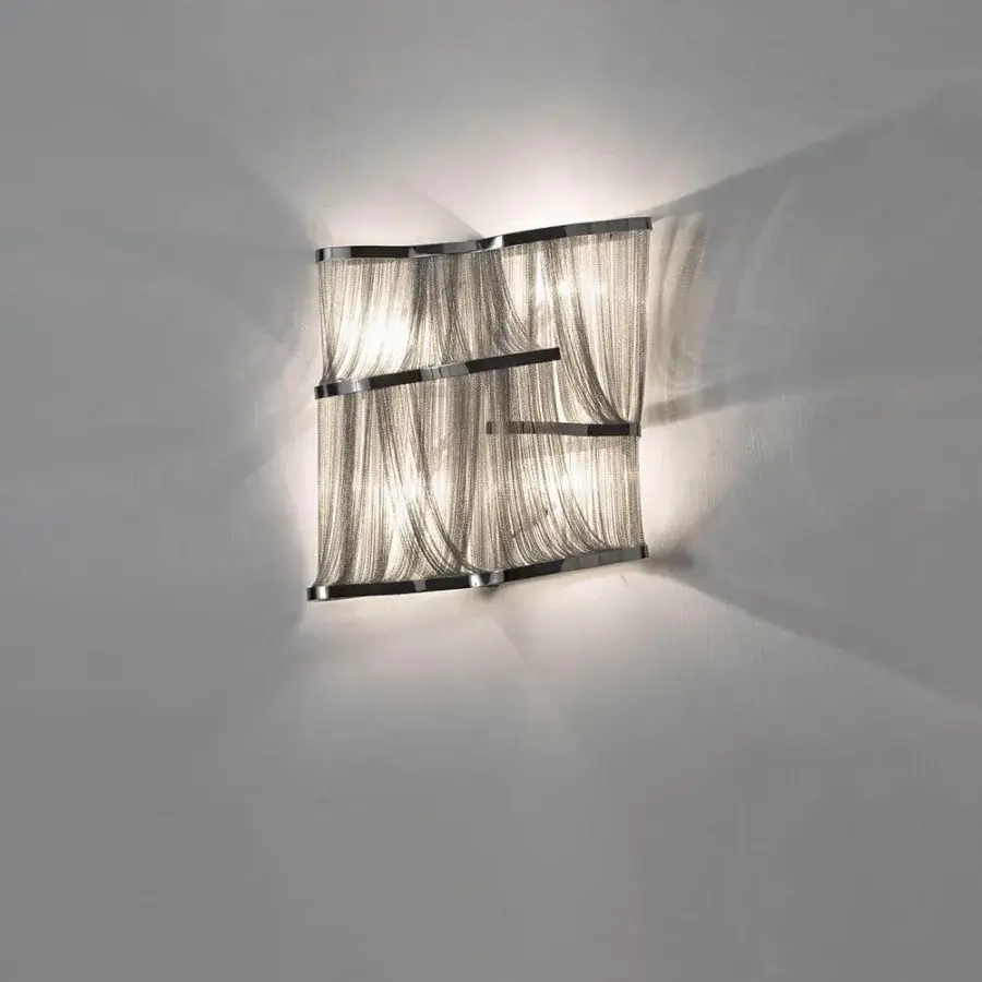 Captivating Terzani Atlantis wall lamp crafted in polished reflective metal with nearly three miles of hand-draped metallic silver toned brass chains