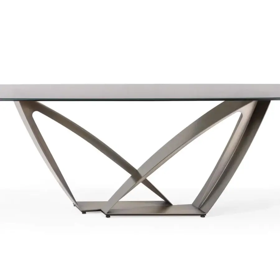 Distinguished Reflex Apeiron table with polished glass top and sculptural base crafted from curved iron in matte bronze or gray tone