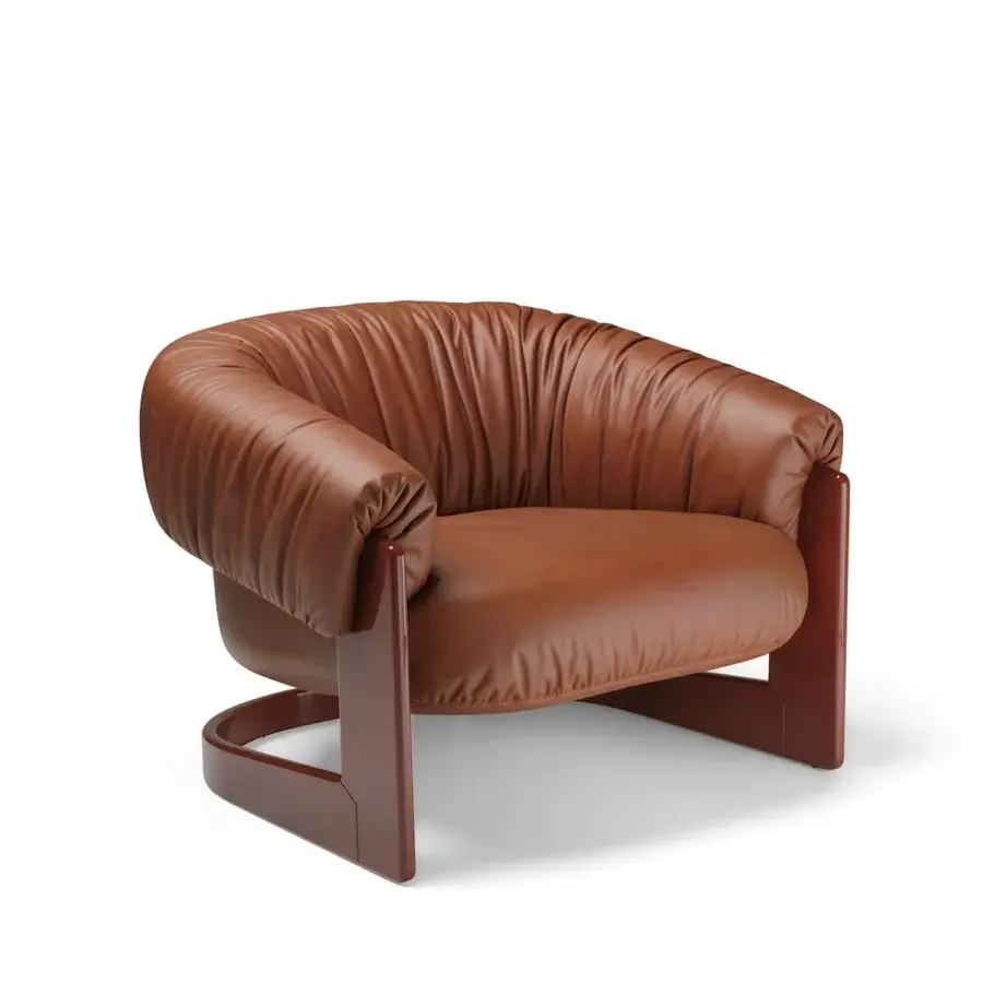Luxury Visionnaire Hampshire lounge chair with continuous organic curve in smooth rich brown leather and high‑gloss layered wood base