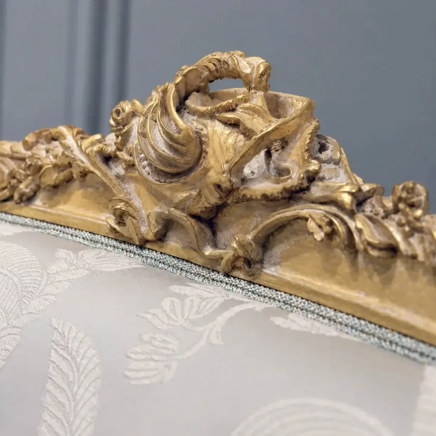 Luxury Bellotti Ezio lounge chair with oak frame finished in patinated gold leaf, off‑white upholstered seat and backrest