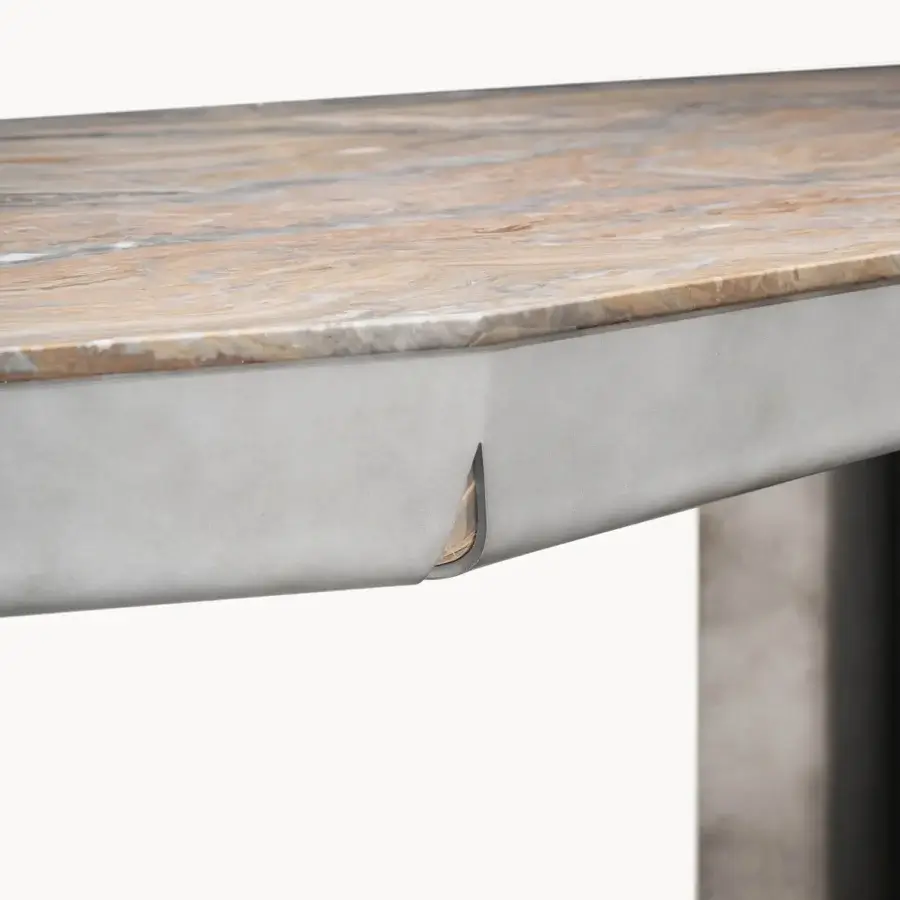 Refined Visionnaire Catskill table with veined beige brown grey marble surface and matte grey metal apron featuring a teardrop cutout