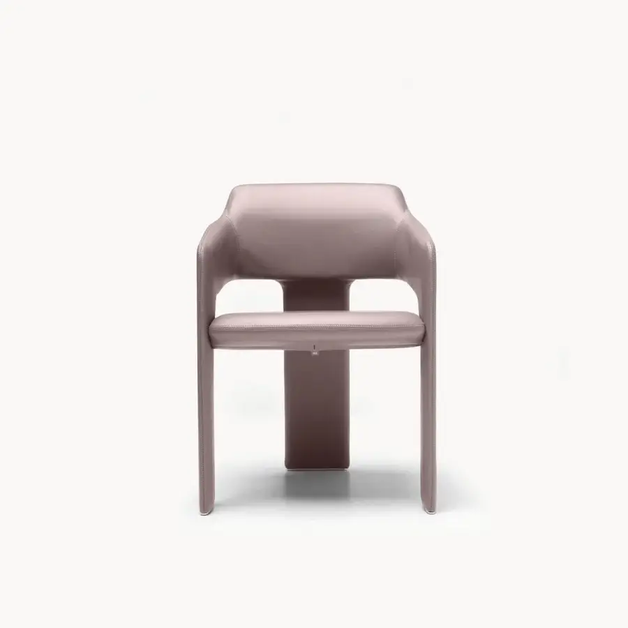 Refined armchair in buttery mauve satin leather with sleek wrap‑around silhouette and central pedestal base