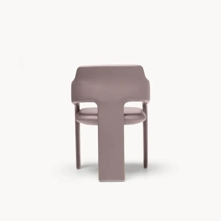 Contemporary Rochester armchair with muted dusky rose matte‑satin upholstery, wide backrest merging with arms, sculptural form