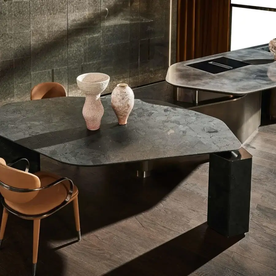 Luxury Visionnaire Titan table with polished charcoal marble surface and subtle veining, supported by stone block legs and metal core
