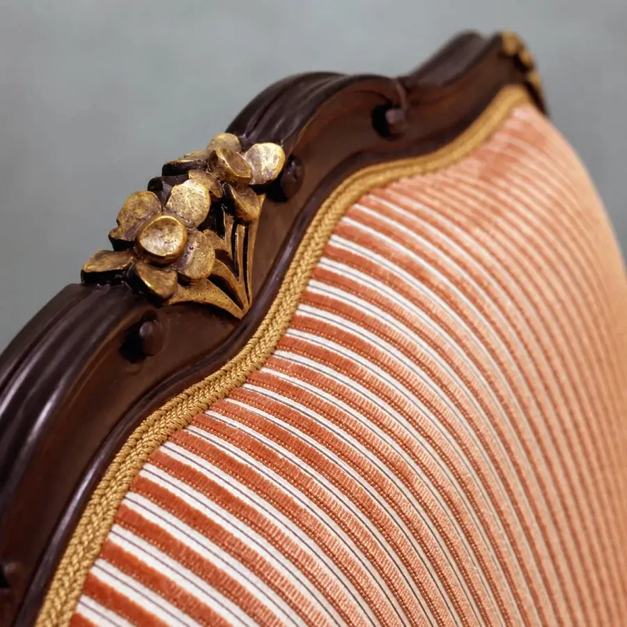 Elegant Bellotti Ezio lounge chair with lacquered wooden frame, orange-white striped fabric, gold floral ornament