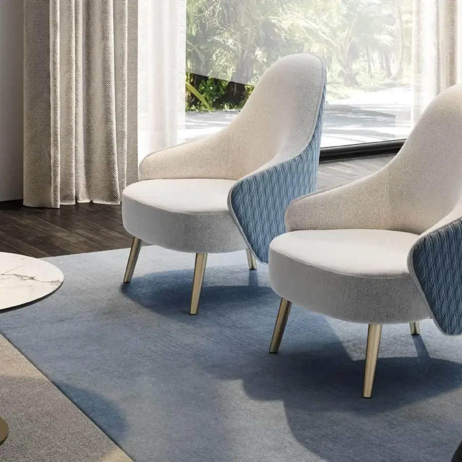 Distinctive Reflex Ludwig lounge chair with light beige fabric upholstery and blue quilted back in golden-toned metal legs