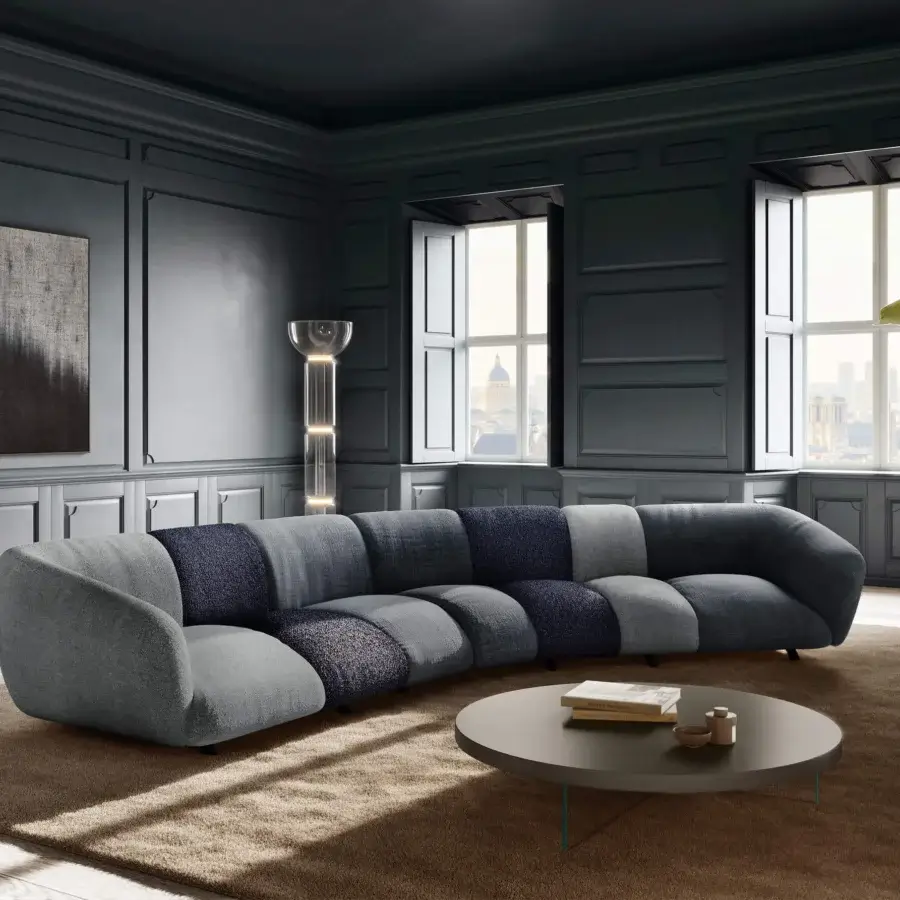 Elegant Lago Not Only White sectional with low‑profile, organically curved silhouette, matte textile in light, medium grey and deep navy blue blocks, small dark legs