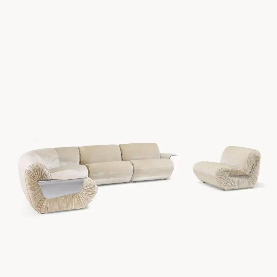 Elegant Visionnaire Joker sectional with light‑toned plush textile, pleated detailing, and shiny silver metal inserts