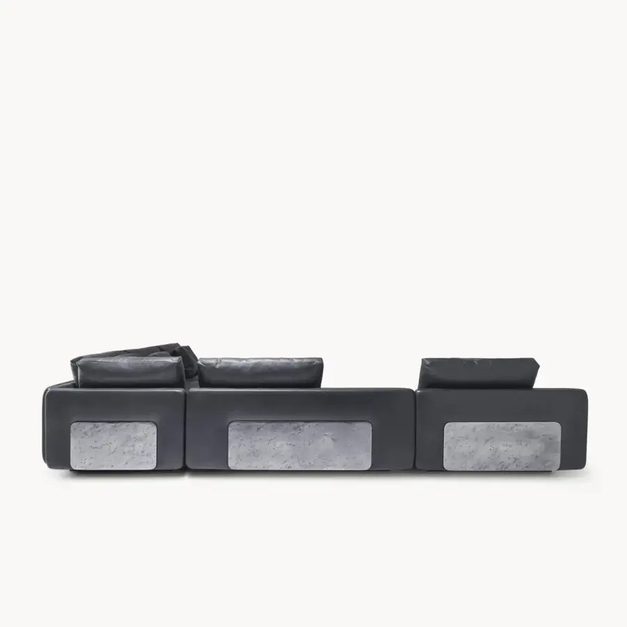 Luxury Visionnaire’s Frame Sectional in matte leather with stark metal armrest and light‑grey stone‑like inset panels