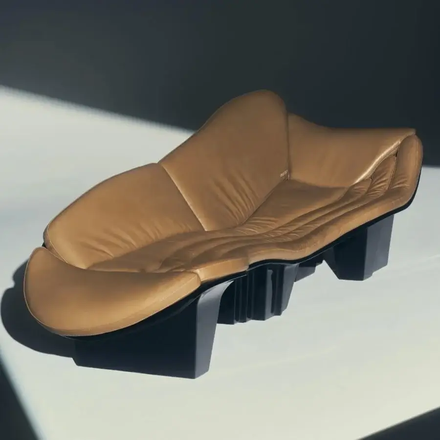 Sleek Visionnaire Blob Sofa sculptural chair in warm tan leather and matte black synthetic base with high-gloss lacquer