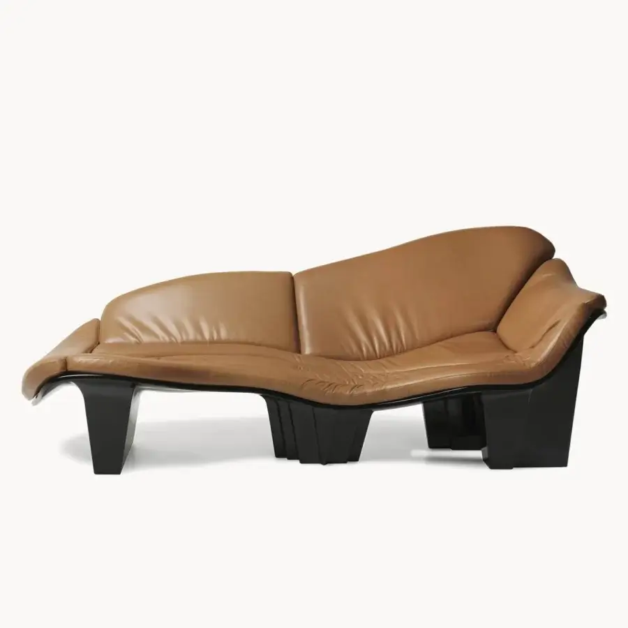 Innovative Visionnaire Blob sofa with robot‑sculpted fluid profile in tan leather and black lacquer shell