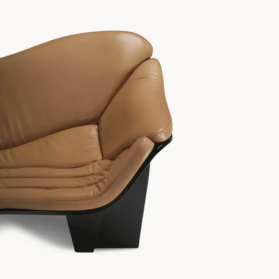 High-end Visionnaire Blob sofa with tan leather upholstery, glossy black base, matte gray steel frame, fluid curvature