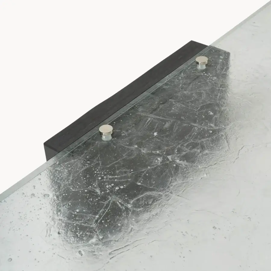 Luxury Visionnaire Stealth coffee table with fractured glass top, Moltrasio stone base, palladium‑finished brass studs, textured frozen water pane, dark matte frame, silver fasteners, black‑tinted counterbalance, translucent silver, deep charcoal, polished brass