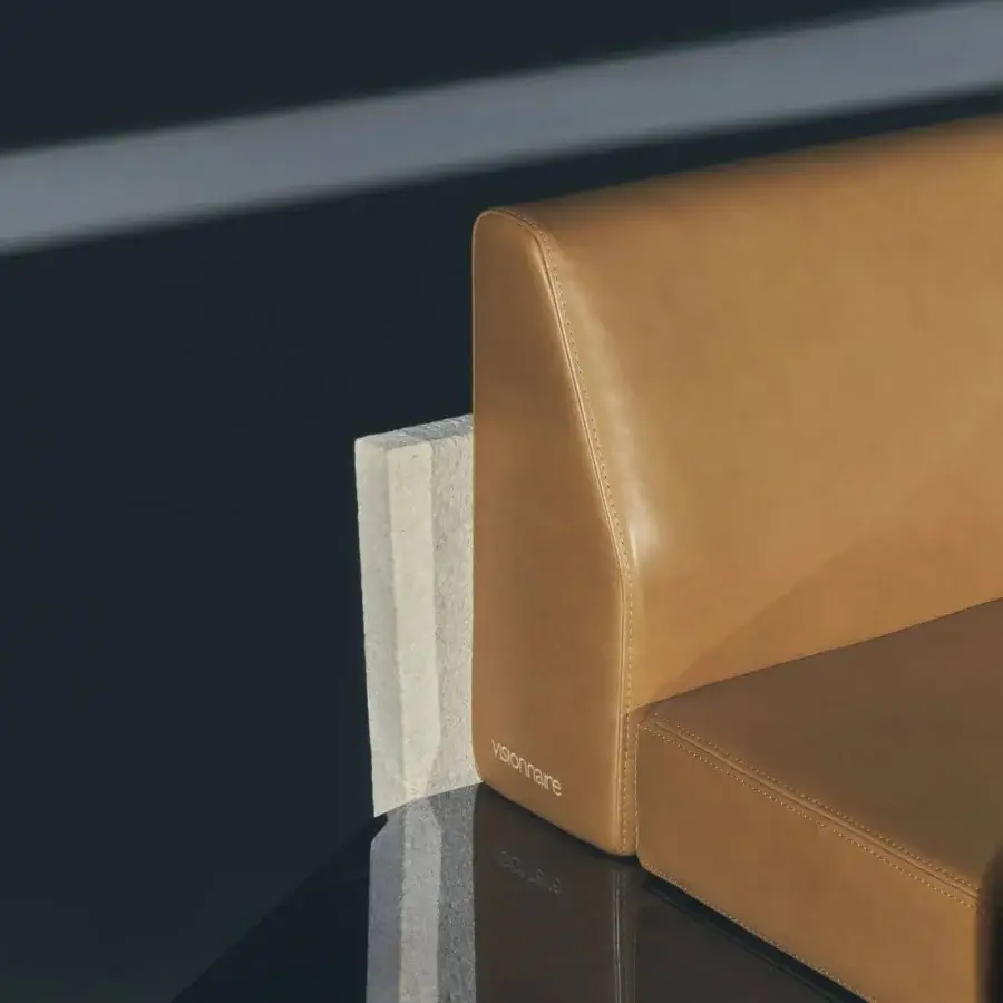 Luxury Visionnaire Stealth sofa with tan leather-like upholstery, high-gloss lacquered wooden frame, sleek tapered backrest