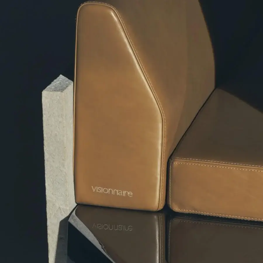 High-end Visionnaire Stealth sofa with warm tan upholstery, architectural boxed seat, and dramatic polygonal profile