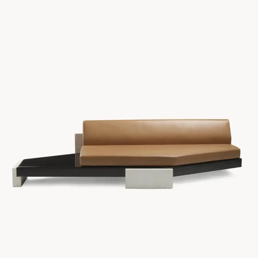 Elegant Visionnaire Stealth sofa with high‑gloss lacquered black platform and smooth tan leather‑like cushions, geometric support blocks