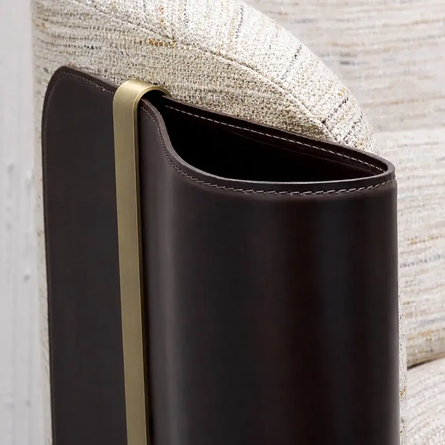 Premium Bellotti Ezio 2026‑01 sofa with dark brown side pocket, stitched rim, muted‑gold metal hook over its edge, set against coarse off‑white textile backdrop
