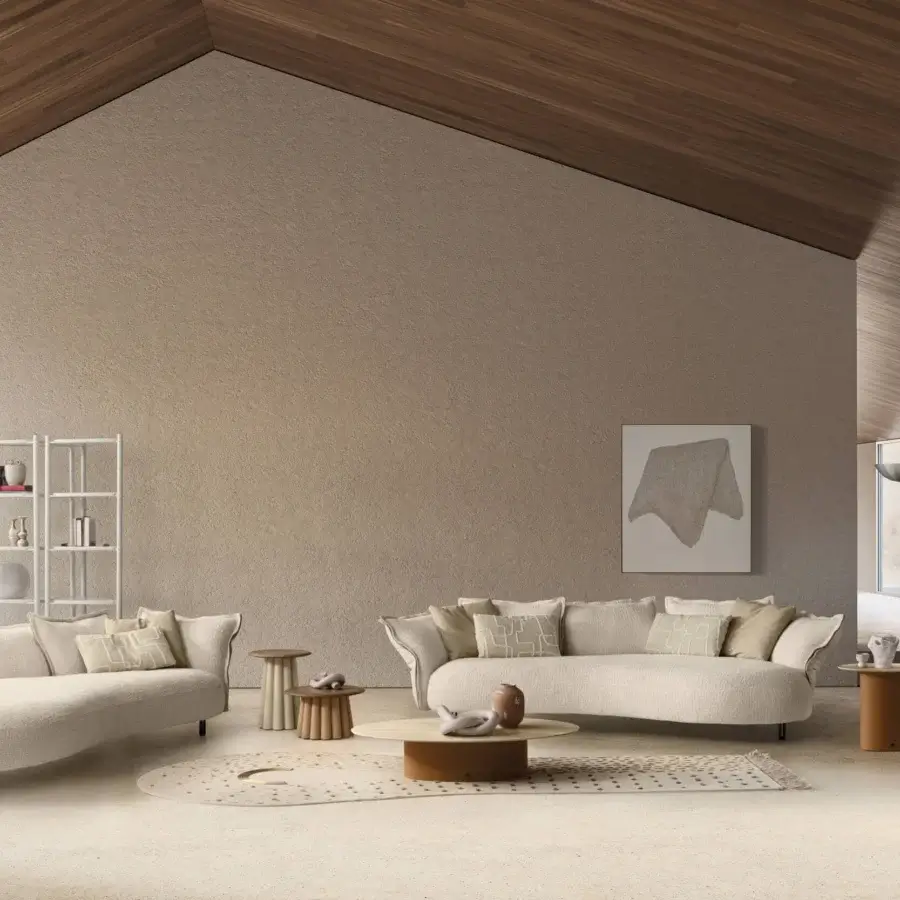 Luxury Nuvola sofa upholstered in cream‑tinted textured textile with dark metal legs and a refined metal armrest plate