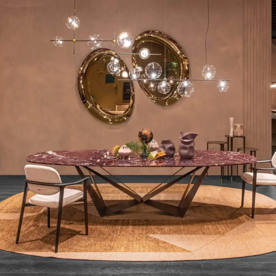 Luxury Cattelan Italia Skorpio Marble dining table featuring glossy oval top in burgundy stone veined white cream and matte angular metal X‑shaped legs