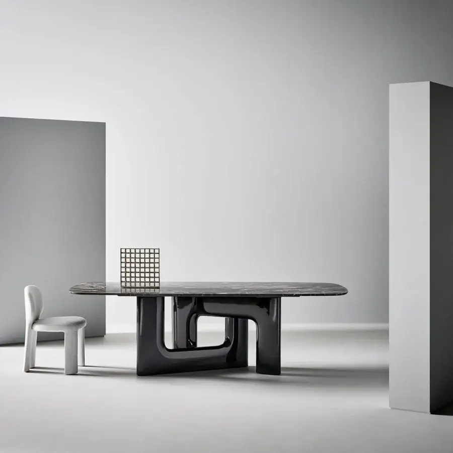 Elegant Bonaldo Liaison table with grey-black marble top veined and glossy black polyurethane base interlocked C shapes