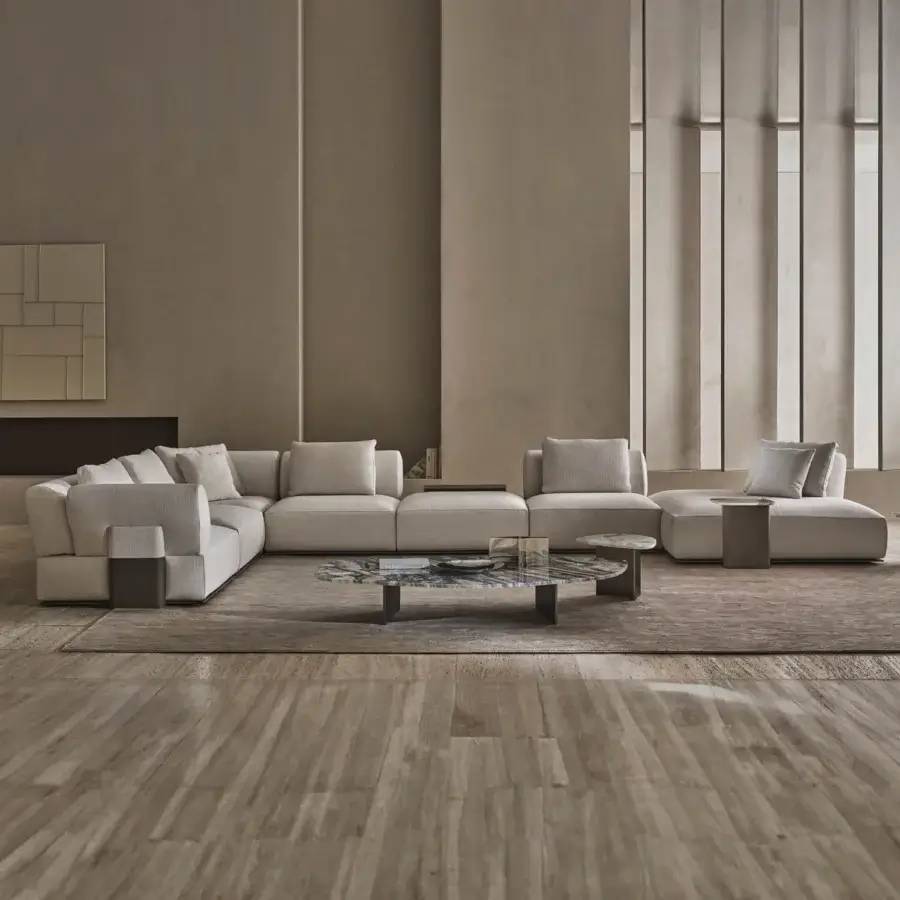 Elegant Rugiano Hatton sectional with low-profile silhouette upholstered in light beige textile leather-wrapped base tables