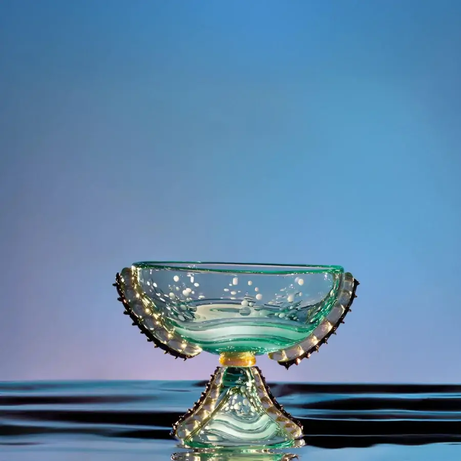 High-end Duccio di Segna centrepiece & vase with translucent glass bowl, gold‑tinted rim, teal‑green aquamarine tones, white bubbles, polished metal pedestal