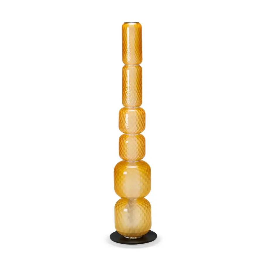 Luxury floor lamp with slender dark base and glossy amber‑golden blown glass featuring Balloton diamond pattern