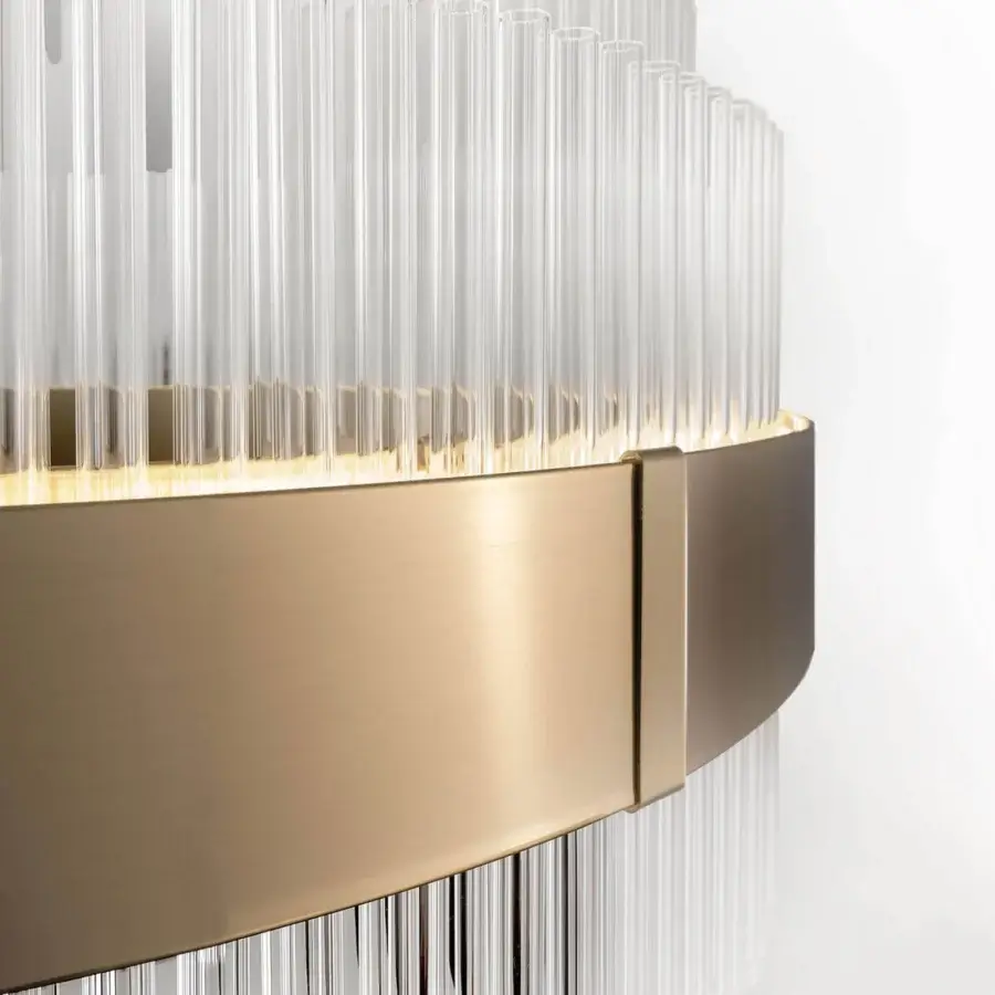 Luxury Italamp Olympia lamp with clear glass tubes, brushed brass band in warm gold, craftsmanship, subtle yellow glow