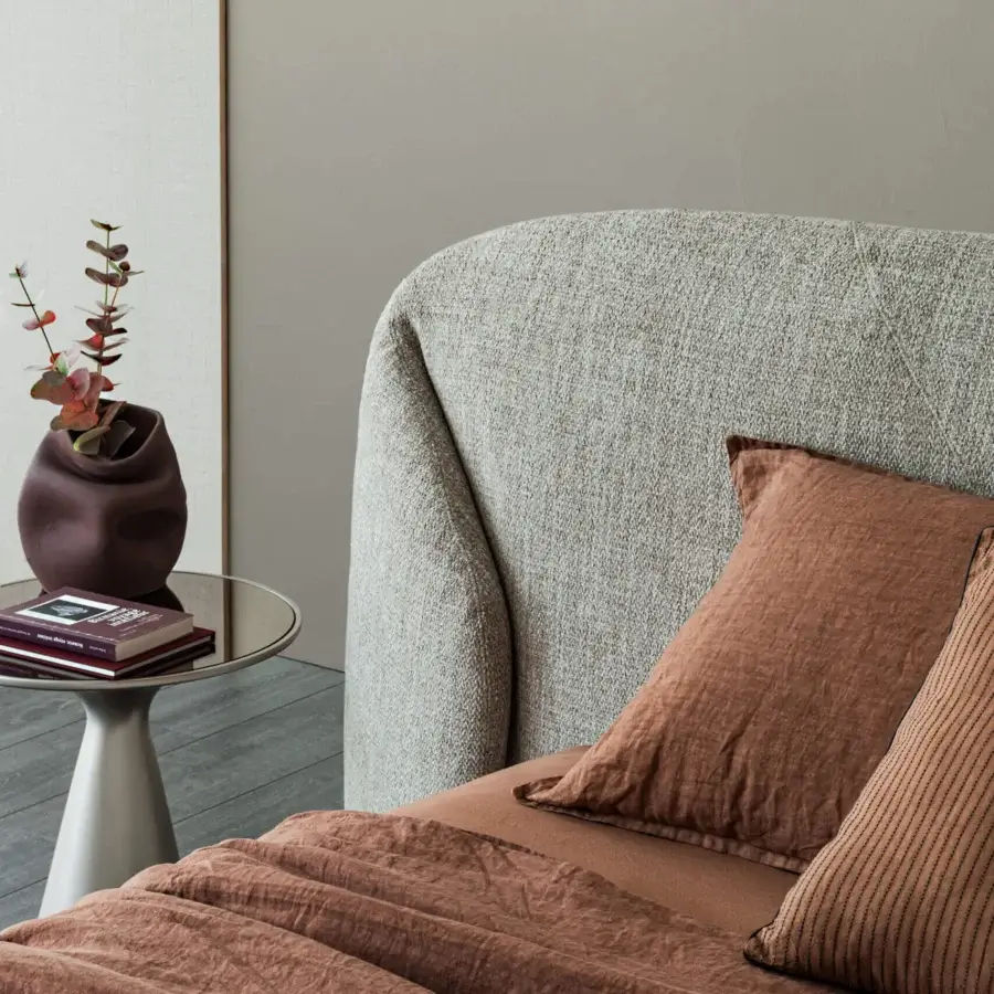 Elegant Cattelan Italia Richard Bed silhouette with curves, light beige‑grey speckled textile matte woven finish