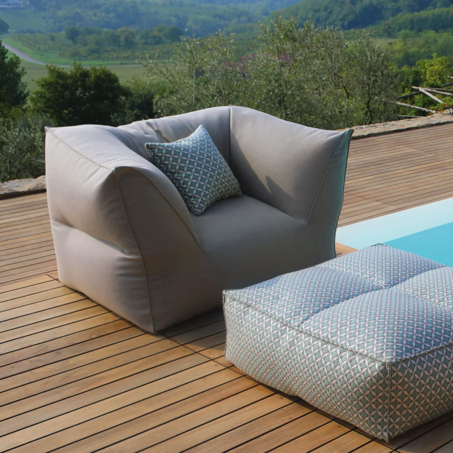 Luxury Gart Puffone lounge chair greyish‑taupe silhouette, ottoman white‑cream blue‑teal accents, padded microspheres, fabric.
