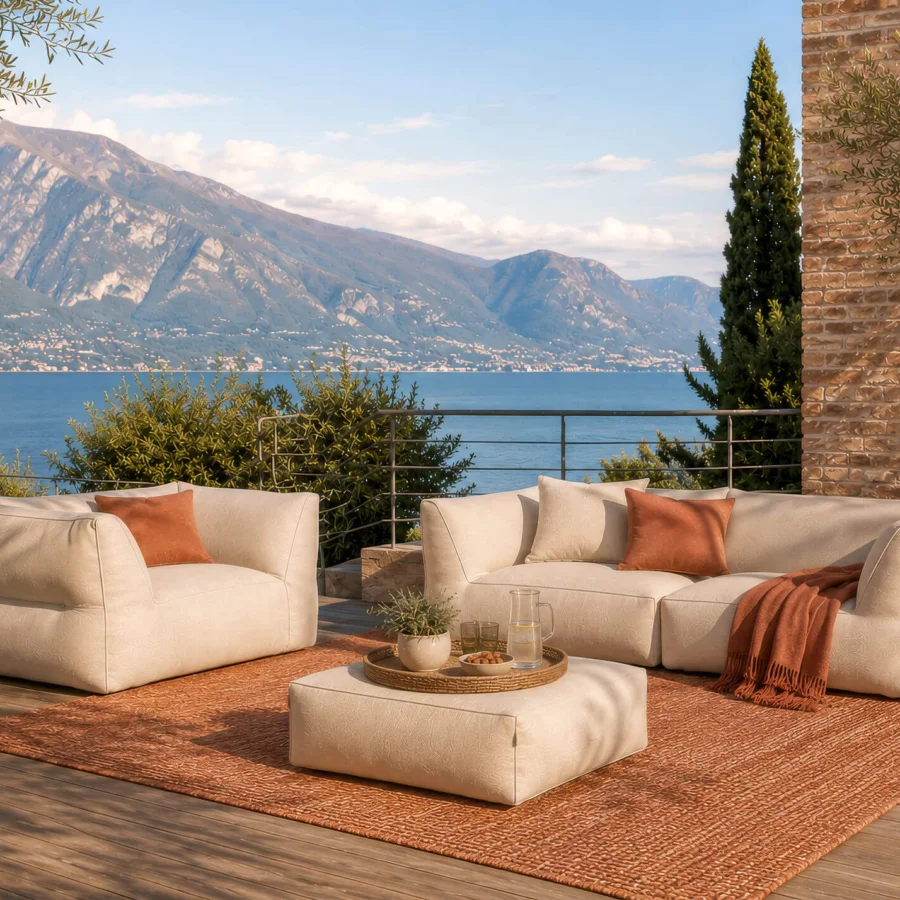 Elegant Gart Puffone lounge chair in off‑white high‑performance outdoor fabric, cubic form, edges, integrated side‑arms, finish