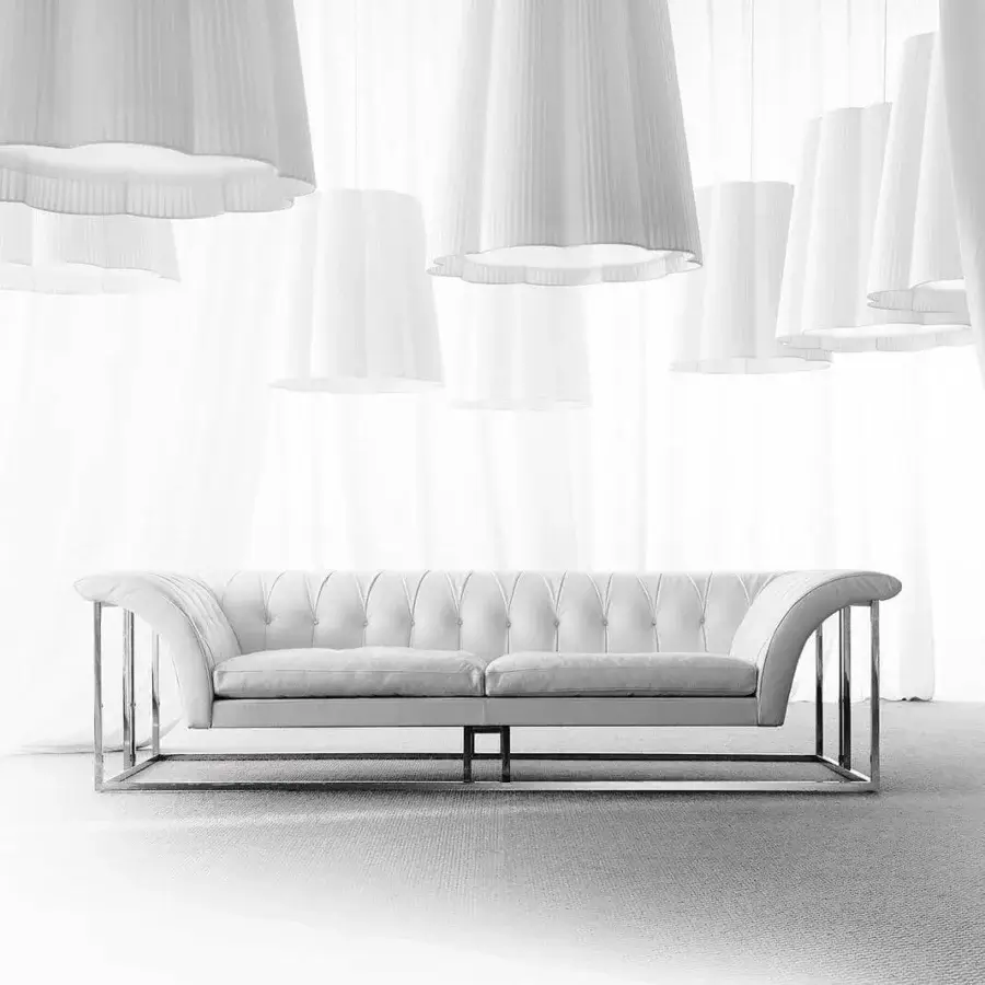 Distinguished Erba Rockouture sofa with curved silhouette and pristine white fabric upholstery built with a bright stainless steel base