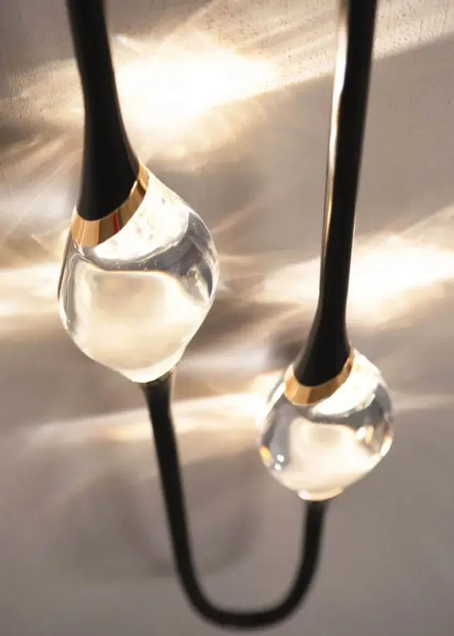 High-end Il Pezzo Mancante wall lamp sculptural sconce in matte brass, crystal diffusers, warm luminous glow on surrounds