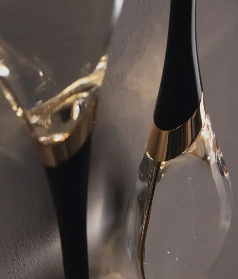 Elegant Il Pezzo Mancante wall lamp with engraved brass cylinder bright gold collar crystal diffuser matte black stem