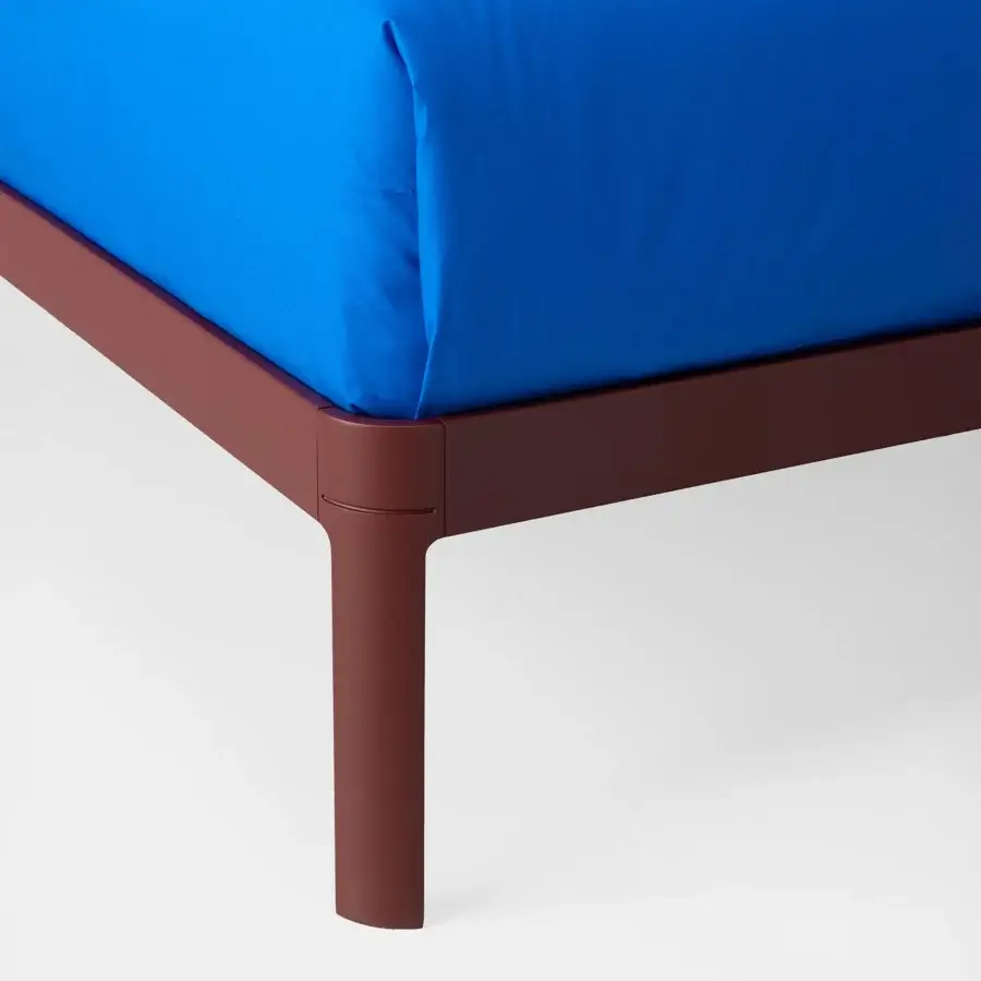 Exquisite Kristalia AluAlu bed with angular deep reddish brown matte metal frame and royal blue smooth textile mattress