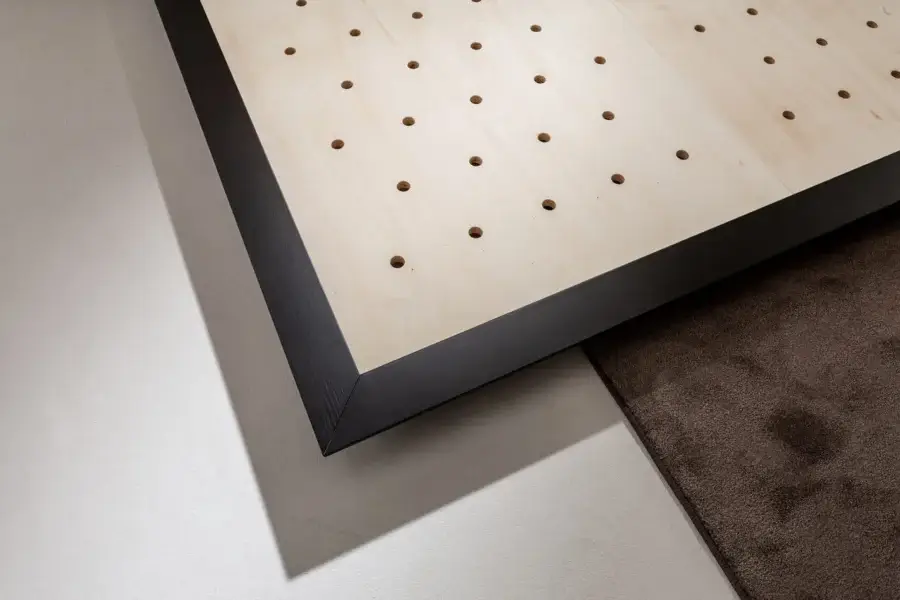 Luxury Laurameroni Symphony Bed black aniline-dyed wood base framing light-beige smooth panel perforated grid circular holes