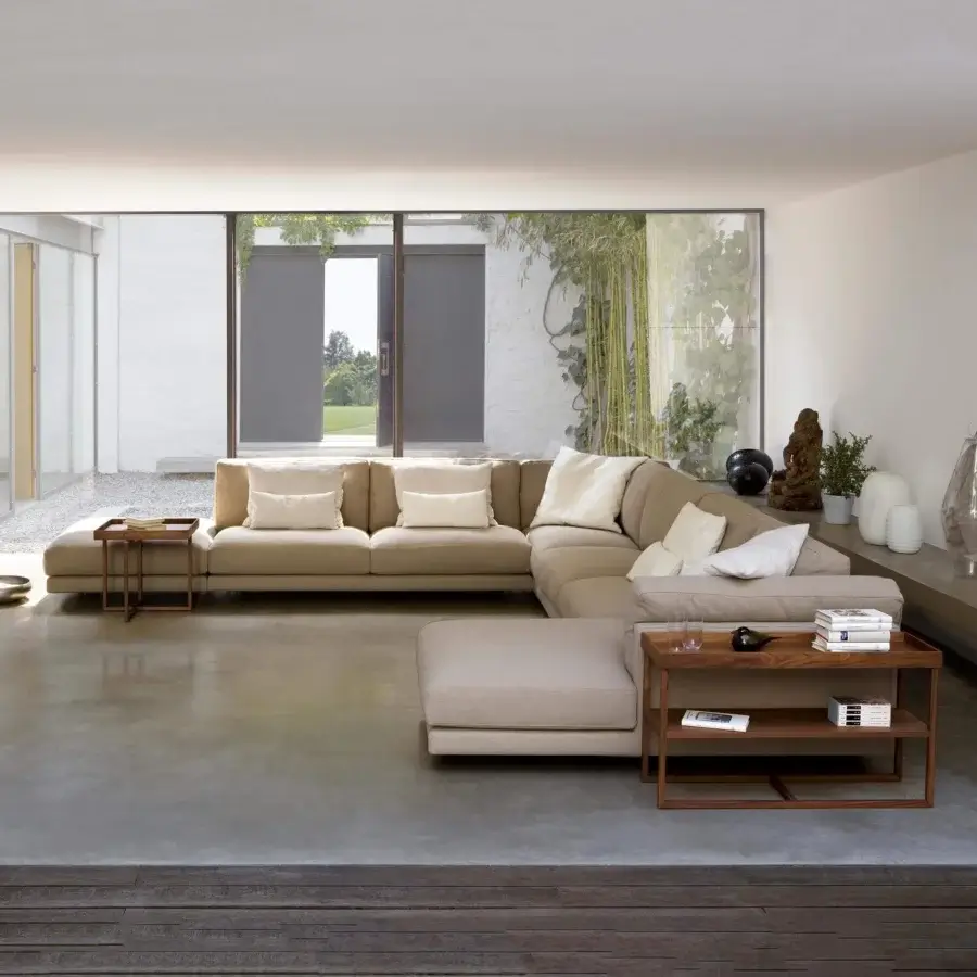 Superior Swan Italia Host sectional with neutral beige velveteen upholstery and powder-coated metal feet, including a wood side table