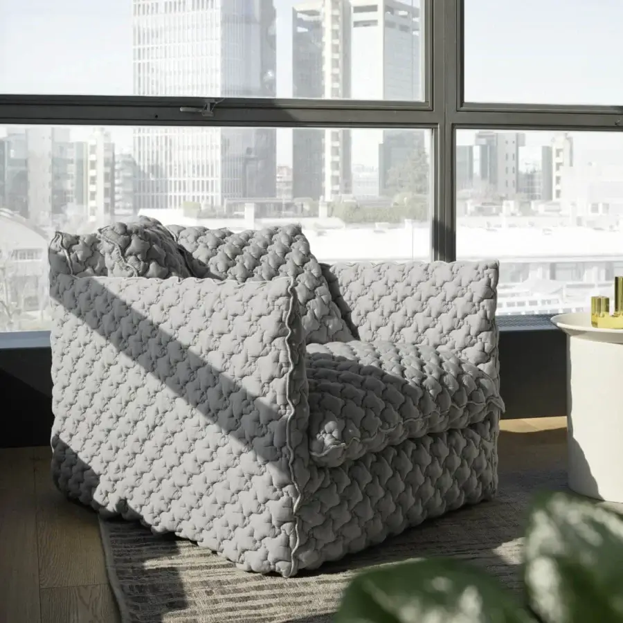 Sumptuous Gervasoni Ghost lounge chair in light gray quilted textile with voluminous low-profile silhouette