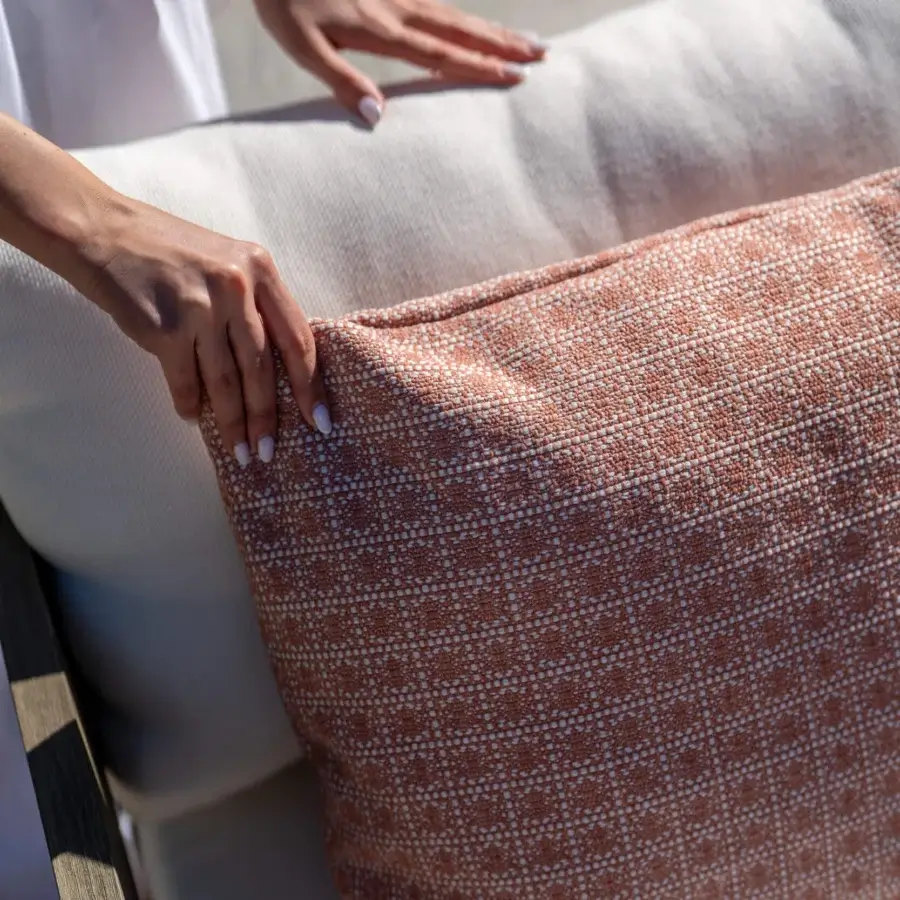 High-end Braid’s Feeling lounge chair with teak frame off‑white textile seat terracotta braided cushion dark armrest silhouette