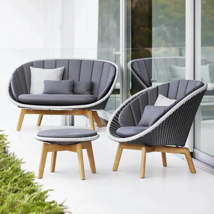 Luxury Cane-Line Peacock side table with grey textile seat and white synthetic woven rim, tapered wooden legs, curved lines