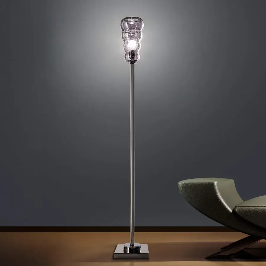 Sophisticated Euroluce Vogue floor lamp with reflective silver-toned metal stem and textured undulating glass shade