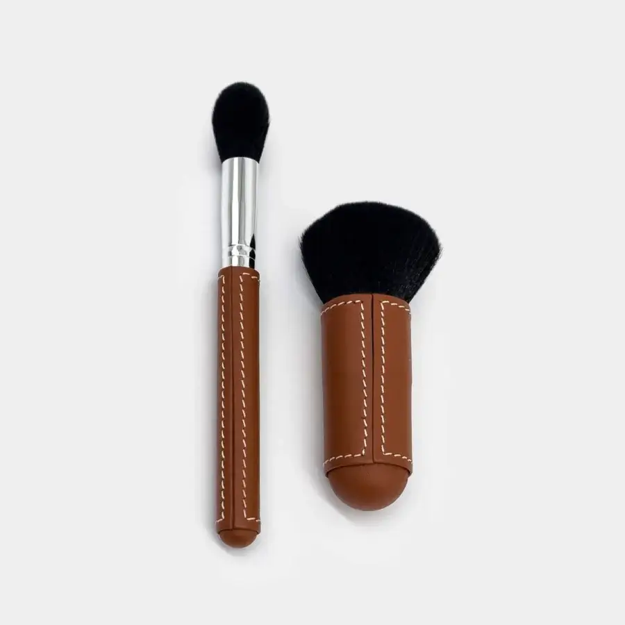 Distinguished Vèlle Milano cleaning brushes with brown leather handles, white stitching, black bristles and silver-toned metal ferrule